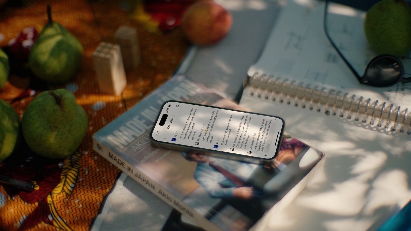 A phone resting on a book in warm sunlight